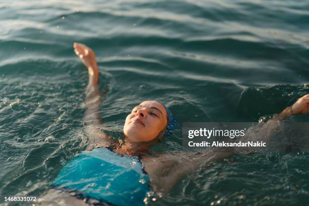 determined athlete's swim training - woman swimming sea stock pictures, royalty-free photos & images