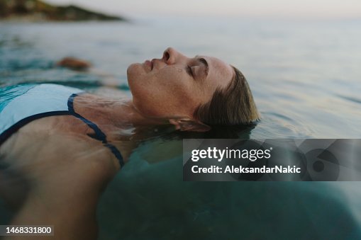 Mid-adult woman swimming in the sea Mid-adult woman swimming in the sea