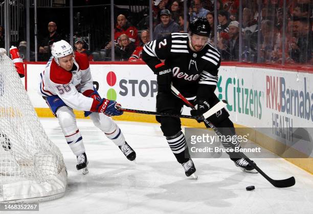 Jesse Ylonen of the Montreal Canadiens checks Brendan Smith of the New Jersey Devils during the first period at the Prudential Center on February 21,...
