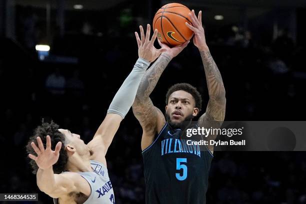 Justin Moore of the Villanova Wildcats attempts a shot while being guarded by Colby Jones of the Xavier Musketeers in the second half at the Cintas...