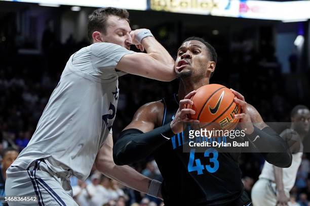 Eric Dixon of the Villanova Wildcats dribbles the ball while being guarded by Jack Nunge of the Xavier Musketeers in the second half at the Cintas...