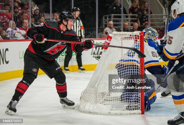 Andrei Svechnikov of the Carolina Hurricanes attempts a shot from behind the net during the third period against the St. Louis Blues at PNC Arena on...