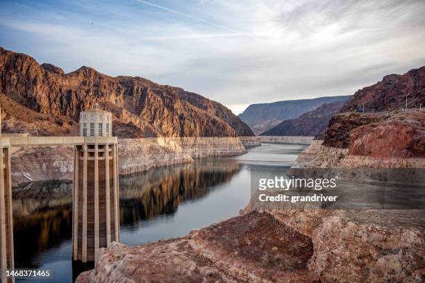 hoover dam at boulder city nevada near las vegas on the arizona border showing very low water levels in lake mead reservoir due to long-term drought conditions in the american southwest - colorado river stock pictures, royalty-free photos & images