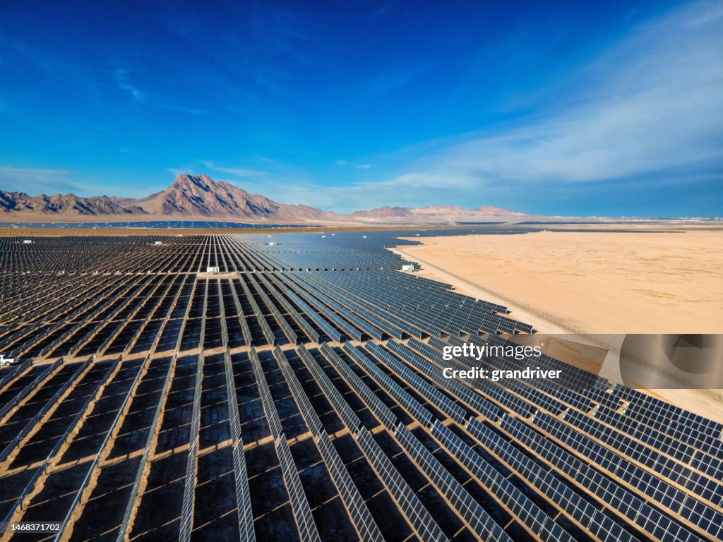 Solar Panel Array Farm in Desert Area South of Boulder City Nevada on a Sunny Day with Sloan Canyon National Conservation Area and North McCullough Mountains