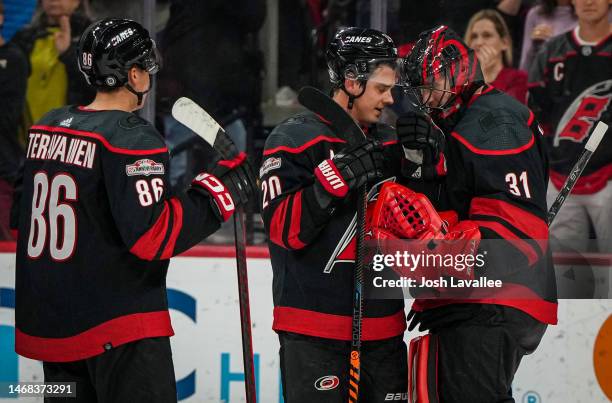The Carolina Hurricanes celebrate after defeating the St. Louis Blues at PNC Arena on February 21, 2023 in Raleigh, North Carolina.