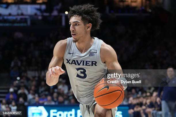 Colby Jones of the Xavier Musketeers dribbles the ball in the first half against the Villanova Wildcats at the Cintas Center on February 21, 2023 in...