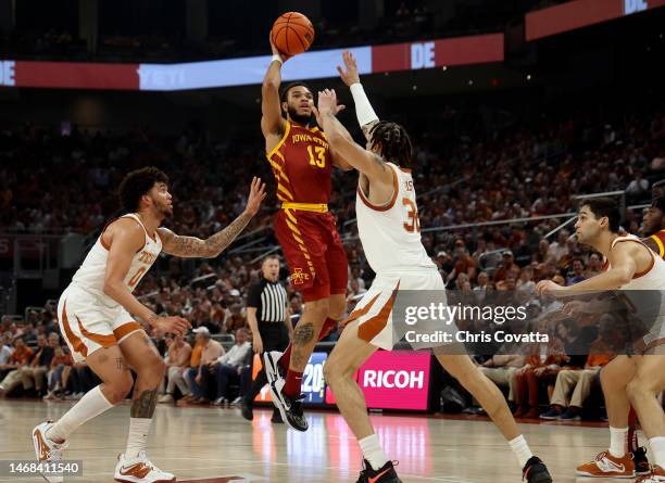 Jaren Holmes of the Iowa State Cyclones shoots between Timmy Allen and Christian Bishop of the Texas Longhorns in the second half of the game at the...