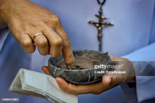 Catholic nun prepares ash to be given to Filipino Catholics as they observe Ash Wednesday at Baclaran Church on February 22, 2023 in Paranaque, Metro...