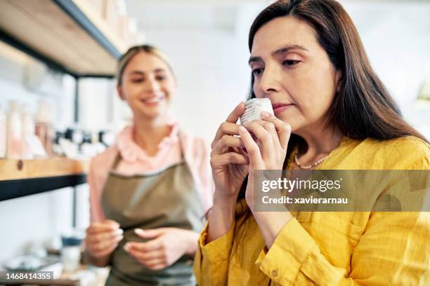 mature customer experiencing beauty product scent - smelling stock pictures, royalty-free photos & images