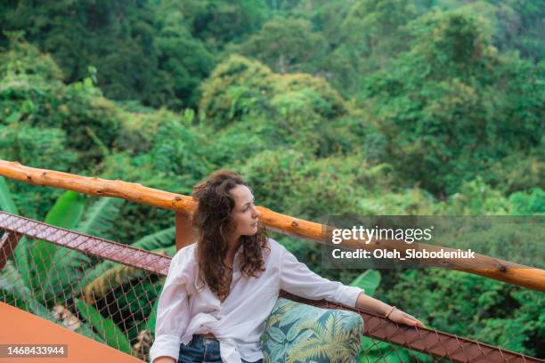 woman sitting on terrace and looking at jungles - thailand hotel stock pictures, royalty-free photos & images