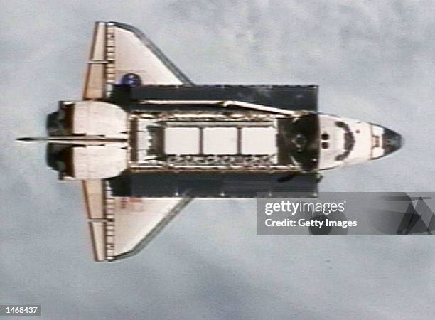 The Space Shuttle Atlantis as seen from the International Space Station before the two dock October 9, 2002. The cargo bay doors are open in this...