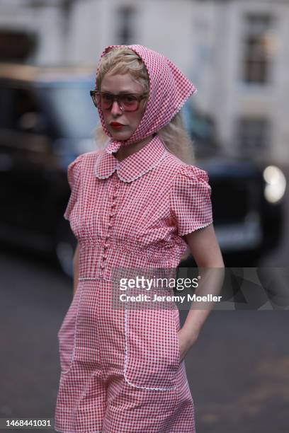 Petite Meller seen wearing a short red and white patterned jumpsuit and matching bandana and red shades before the PAUL and JOE show during London...
