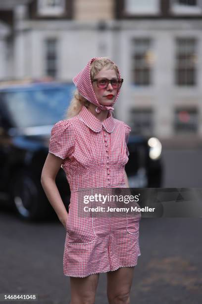 Petite Meller seen wearing a short red and white patterned jumpsuit and matching bandana and red shades before the PAUL and JOE show during London...