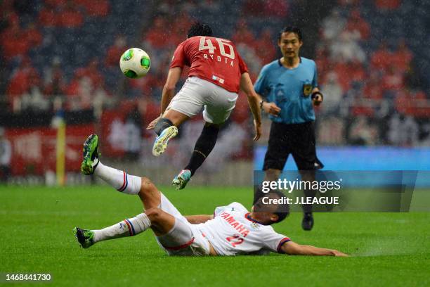 Ryota Moriwaki of Urawa Red Diamonds is tackled by Jung Woo Young of Jubilo Iwata during the J.League J1 match between Urawa Red Diamonds and Jubilo...