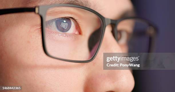 male eye closeup with eyeglasses - eye lens stock pictures, royalty-free photos & images