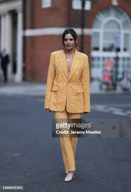 Lilah Parsons seen wearing a matching yellow flower patterned suit and high heels before the PAUL and JOE show during London Fashion Week on February...
