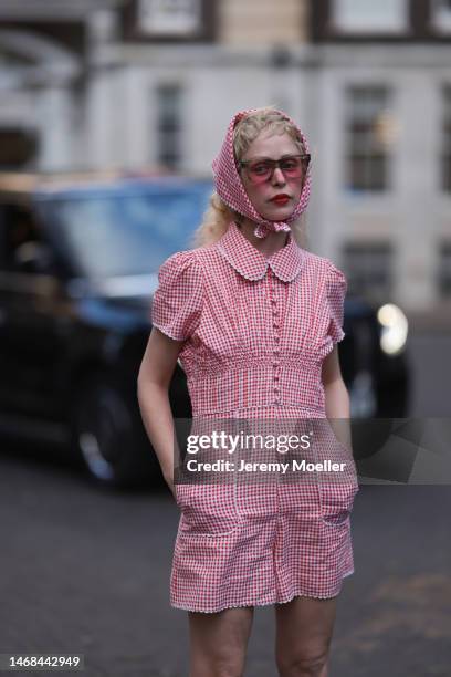 Petite Meller seen wearing a short red and white patterned jumpsuit and matching bandana and red shades before the PAUL and JOE show during London...