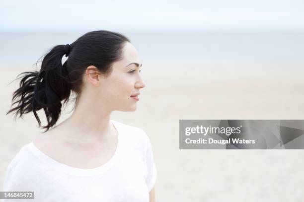 profile of woman at beach. - hair back stock pictures, royalty-free photos & images