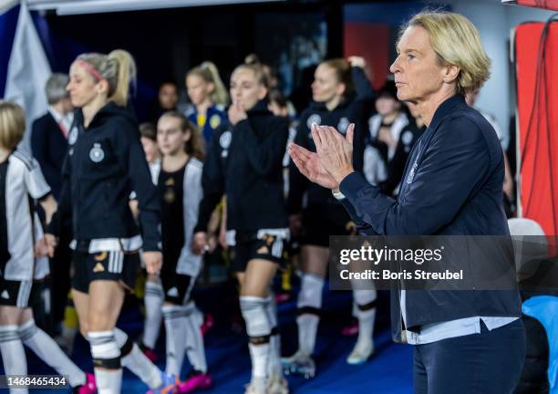 National coach Martina Voss-Tecklenburg of Germany applauds prior to the Women's friendly match between Germany and Sweden at...