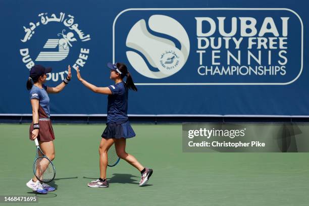 Shuko Aoyama of Japan and Makoto Ninomiya of Japan celebrates scoring a point against Zhaoxuan Yang of China and Vera Zvonareva during their women's...