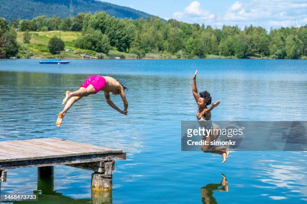 couple jumping in lake - dive stock pictures, royalty-free photos & images