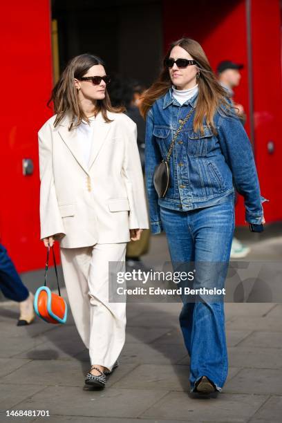 Guest wears black sunglasses, a white t-shirt, a white latte oversized blazer jacket, white latte large pants, black shiny leather nailed / studded...