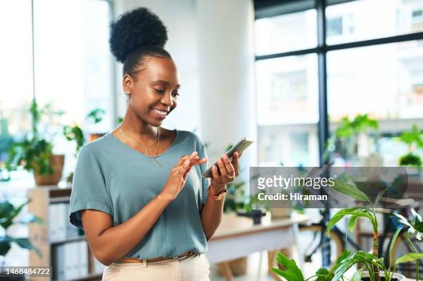 black woman, phone and typing in office for contact, data management app and reading business notification. happy female worker, smartphone and mobile connection for networking, technology and media - creative agency stock pictures, royalty-free photos & images