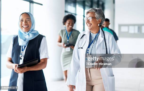 happy, smile and diverse doctors after successful surgery at the hospital in dubai with a muslim nurse wearing hijab. team, success and medical or healthcare professionals laughing and excited - nurse manager stock pictures, royalty-free photos & images