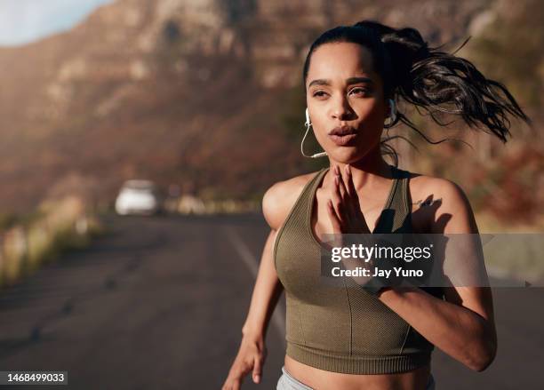 breathe, music and woman running in the street for fitness, training and marathon in the mountains. sports, workout and runner in the road with a podcast while doing an outdoor exercise in germany - exercise routine stock pictures, royalty-free photos & images