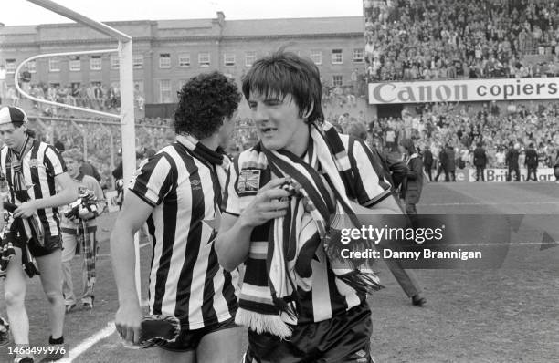 Newcastle United players Chris Waddle John Trewick and Peter Beardsley celebrate on the pitch after their 4-0 victory over Derby County which all but...