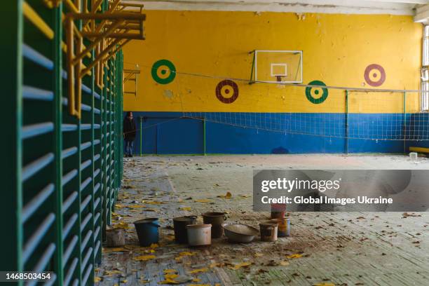 The damage from the war evident in the school's sports room on February 1, 2023 in Staryi Saltiv, Ukraine. The plaster has come off the walls and...