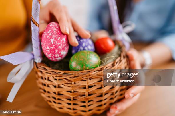 an easter egg basket with eggs - easter basket stock pictures, royalty-free photos & images