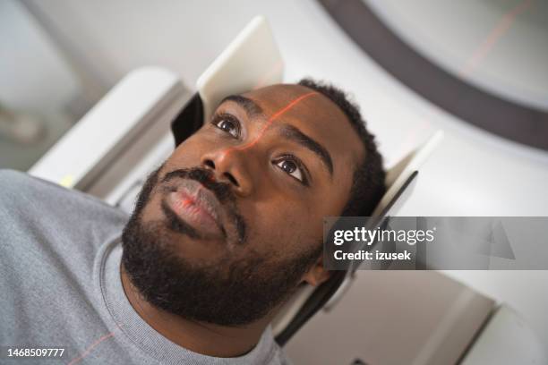 male patient undergoing mri scan in medical examination room - mri scan medische scan stockfoto's en -beelden