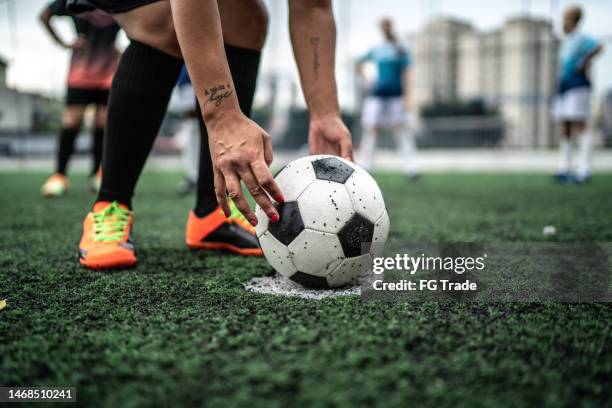 low section of a female soccer player placing the ball for a free kick - fault sports stock pictures, royalty-free photos & images