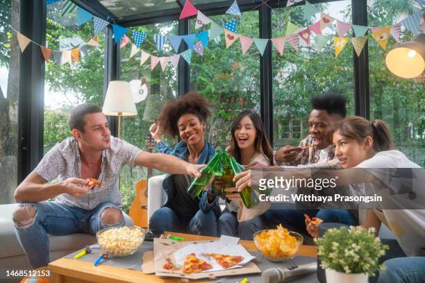 diverse group of young people partying - house warming stock pictures, royalty-free photos & images