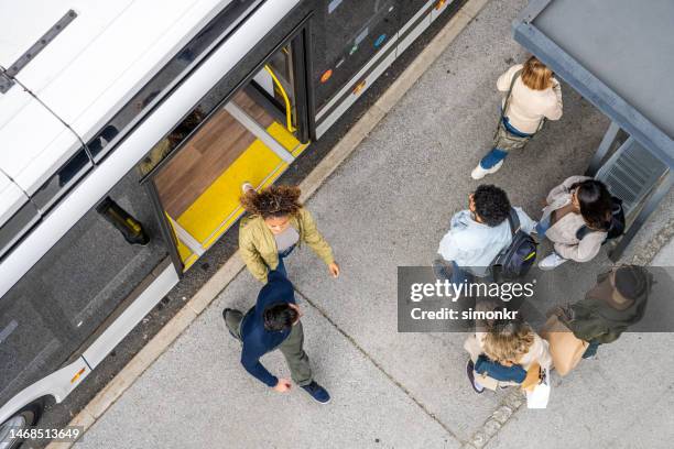 passengers exiting from bus - getting out stock pictures, royalty-free photos & images