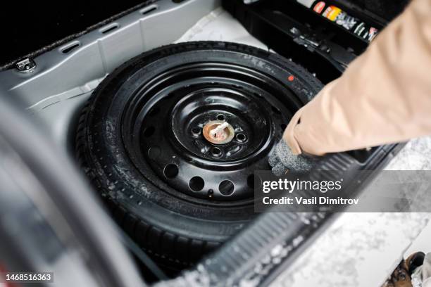 we have a problem here. spare tire in car trunk - reserveband stockfoto's en -beelden