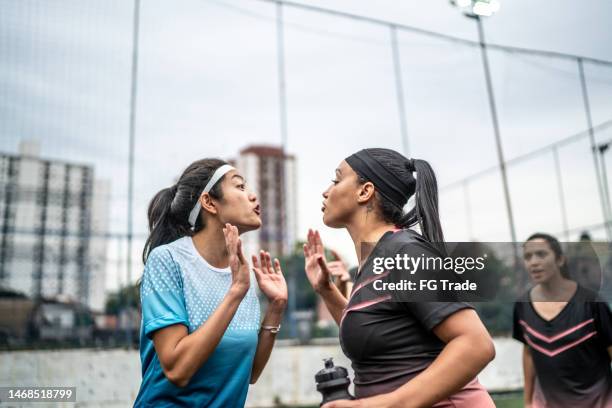 female soccer players arguing and fighting during match - fighting game stock pictures, royalty-free photos & images