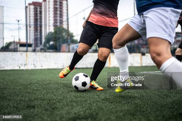 low section of female soccer players during a match - dribbelen stockfoto's en -beelden