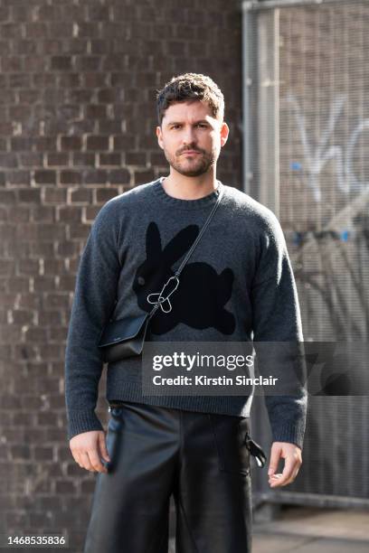 Ben Aldridge wears a JW Anderson jumper, shorts and bag during London Fashion Week February 2023 on February 19, 2023 in London, England.