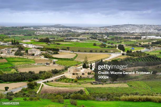 high angle view of agricultural field against sky,mdina,malta - wayne gerard trotman stockfoto's en -beelden