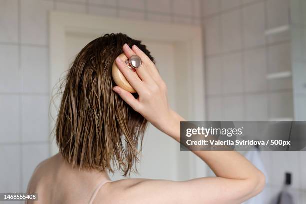 woman makes a head self massage for hair growth,kyiv,ukraine - wet hair stock pictures, royalty-free photos & images