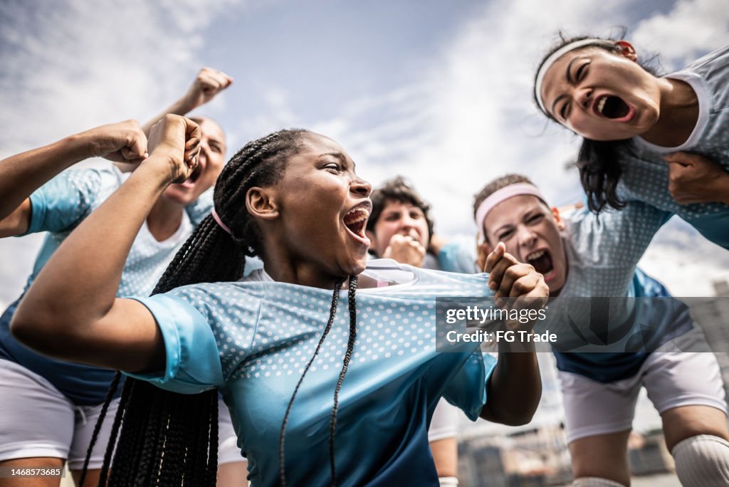 Portrait of a female soccer team celebrating