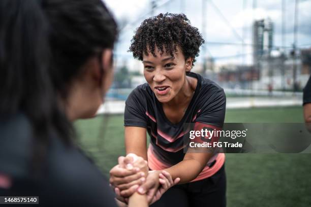 female soccer team captain encouraging colleague before match - team captain stock pictures, royalty-free photos & images