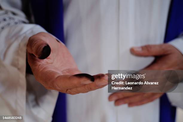 Priest shows his hand covered with ash during a mass as part of the Ash Wednesday on February 22, 2023 in Guadalajara, Mexico.