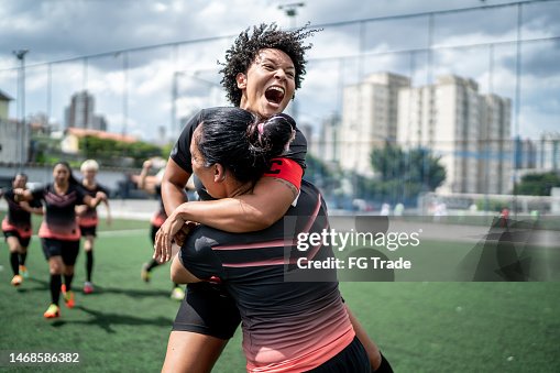 Female soccer team celebrating