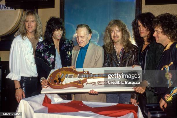 American rock band Aerosmith host a party for Les Paul celebrating his 75th birthday. Seen here with Les Pauls birthday cake on June 12, 1990 at The...