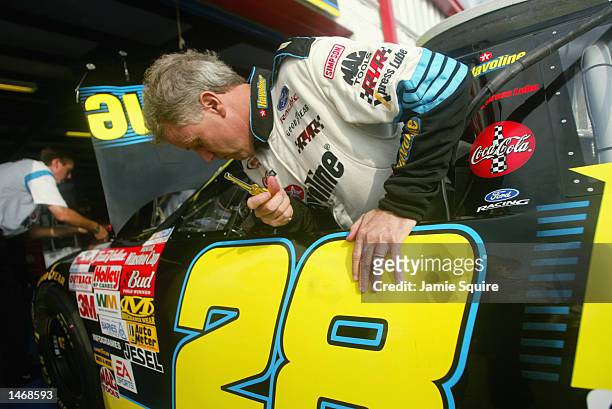 Ricky Rudd, driver of the Havoline Racing Ford Taurus, works on his car in the garage during practice for the EA Sports 500 at Talladega...
