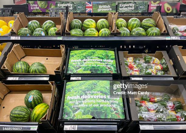 Empty shelves and boxes are seen alongside fruit and vegetables that are being are offered for sale inside a branch of the supermarket retailer Asda...