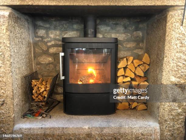 Logs burn on a wood burning stove at Cape Cornwall on February 13, 2023 in Cornwall, England. There have been calls for an urgent review of...